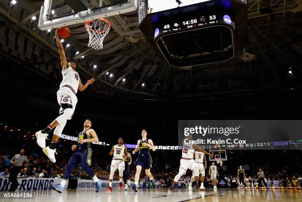 Dozier of the South Carolina Gamecocks goes up for a shot against Andrew Rowsey of the Marquette Golden Eagles in the second half during the first...