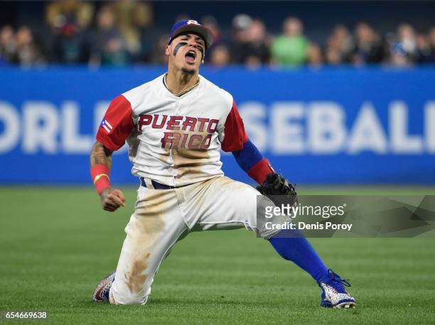 Javier Baez of Puerto Rico reacts after getting the out on Eric Hosmer of the United States during the sixth inning of the World Baseball Classic...