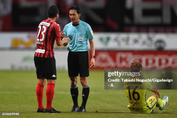 Referee Hiroyuki Kimura talks to Macedo of Consadole Sapporo pefore showing a yellow card by during the J.League J1 match between Consadole Sapporo...