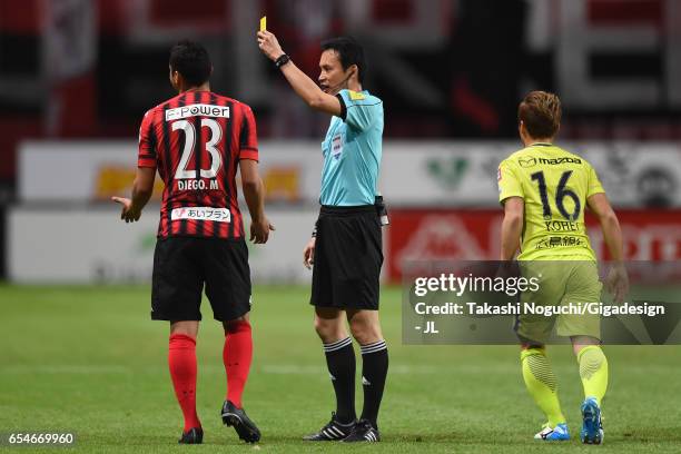 Macedo of Consadole Sapporo is shown a yellow card by referee Hiroyuki Kimura during the J.League J1 match between Consadole Sapporo and Sanfrecce...