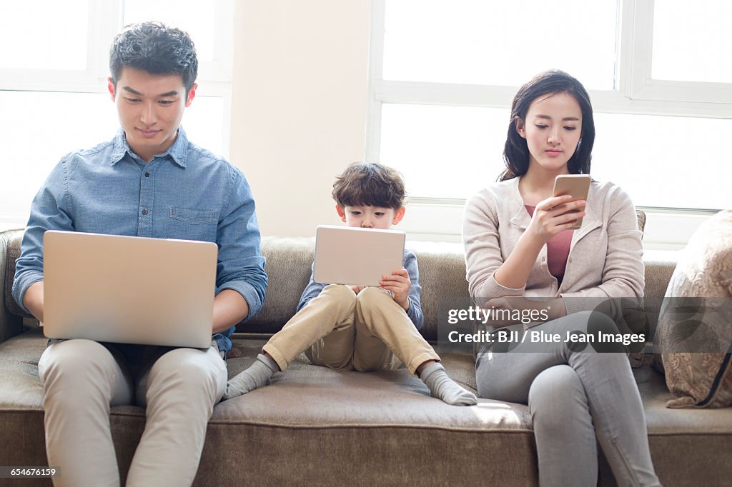 Young family addicting to internet