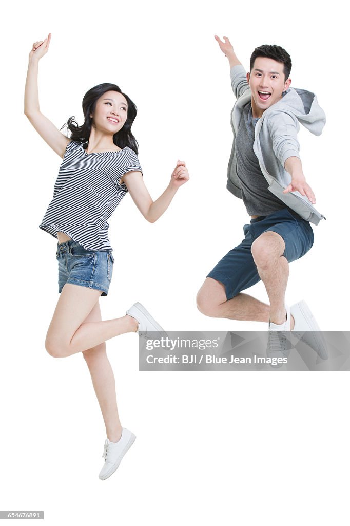 Happy young couple jumping