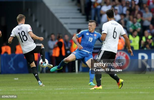 Toni Kroos of Germany and Juraj Kucka of Slovakia and Sami Khedira of Germany battle for the ball during the UEFA EURO 2016 round of 16 match between...