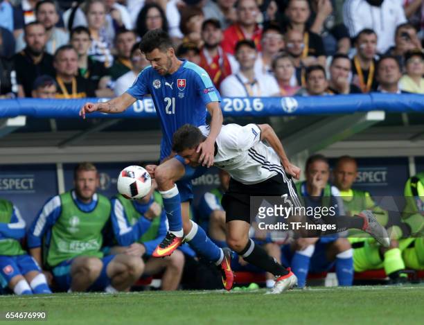 Michal Duris of Slovakia and Jonas Hector of Germany battle for the ball during the UEFA EURO 2016 round of 16 match between Germany and Slovakia at...