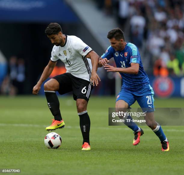 Sami Khedira of Germany and Michal Duris of Slovakia battle for the ball during the UEFA EURO 2016 round of 16 match between Germany and Slovakia at...