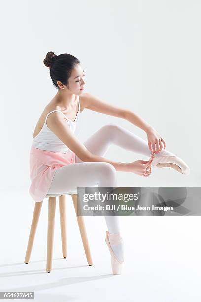 ballet dancer tying up pointe shoes - lace fastener bildbanksfoton och bilder