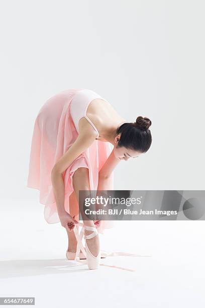 ballet dancer tying up pointe shoes - lace fastener stock pictures, royalty-free photos & images