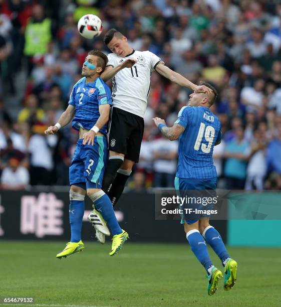 Peter Pekarik of Slovakia and Julian Draxler of Germany and Juraj Kucka of Slovakia battle for the ball during the UEFA EURO 2016 round of 16 match...