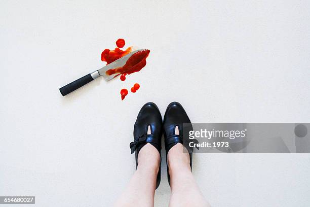 bloody knife on floor next to woman's feet - vedova nera foto e immagini stock