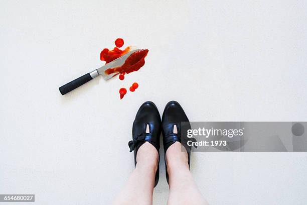 bloody knife on floor next to woman's feet - black widow spider stock pictures, royalty-free photos & images