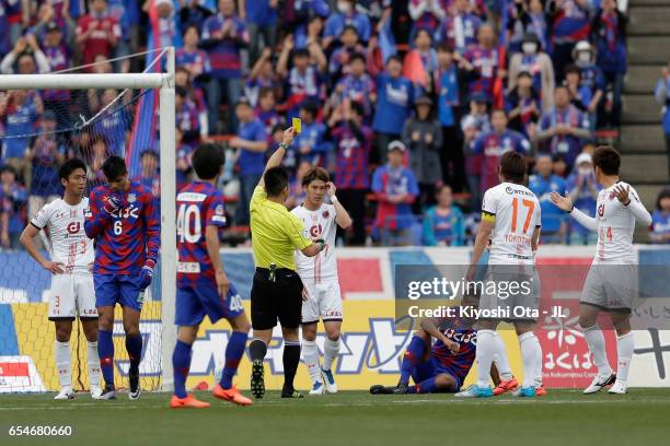 Referee Akihiko Ikeuchi shows an yellow card to Dragan Mrdja of Omiya Ardija after fouling on Wilson of Ventforet Kofu in the penalty area during the...