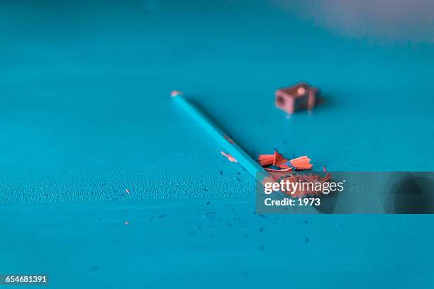 blue pencil and pencil sharpener - wood shavings stock pictures, royalty-free photos & images