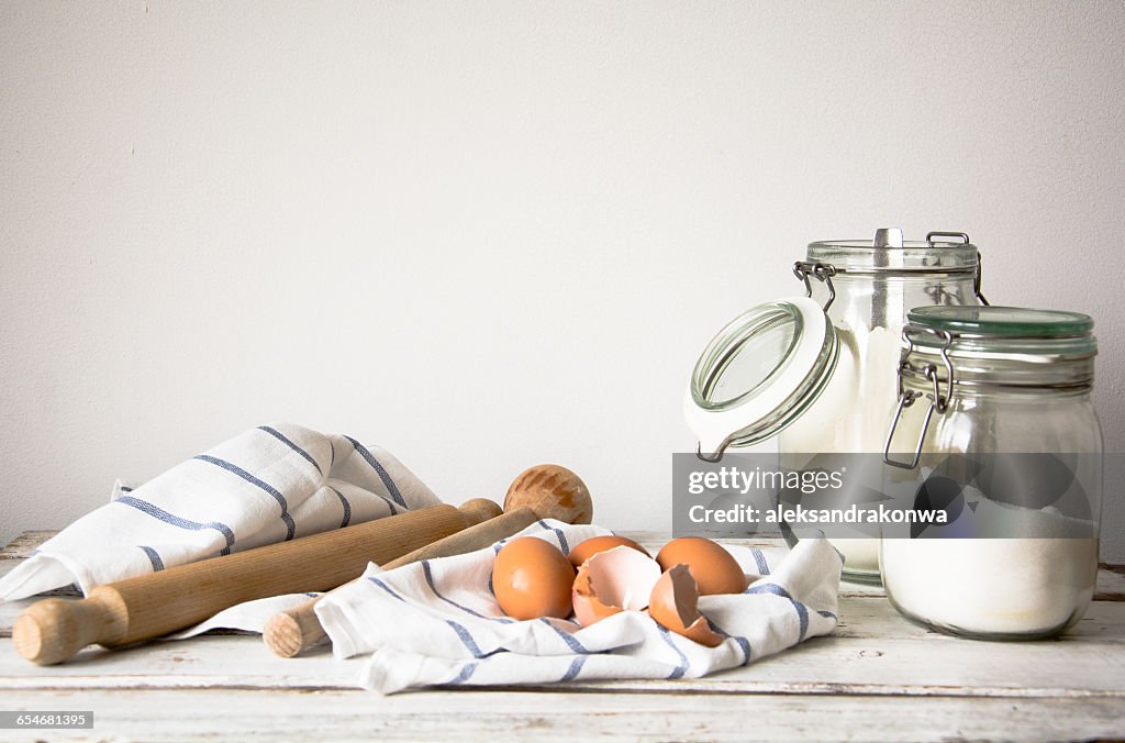 Flour, sugar, eggs, rolling pin and tea towel