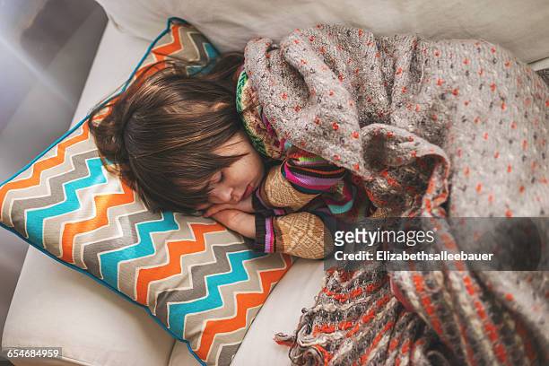 girl sleeping on sofa - sick child stock-fotos und bilder