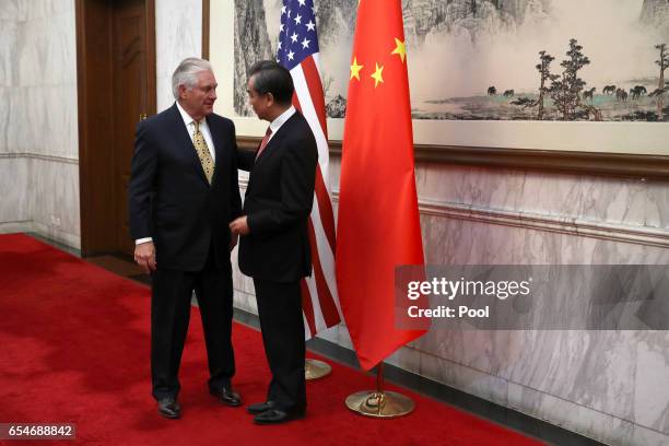 Secretary of State Rex Tillerson, left, talks with Chinese Foreign Minister Wang Yi, right, as he arrives for a bilateral meeting with U.S. Secretary...