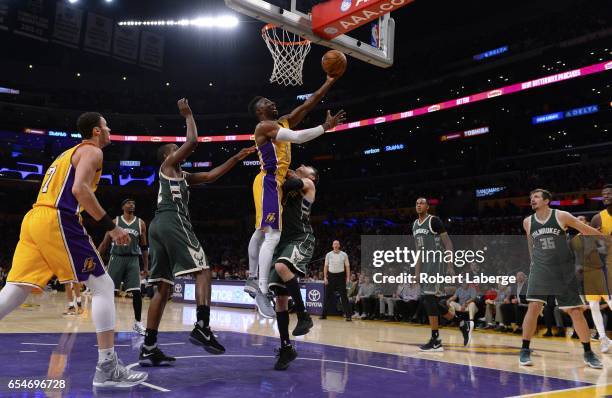 David Nwaba of the Los Angeles Lakers attempts a lay up against Matthew Dellavedova of the Milwaukee Bucks on March 17, 2017 at STAPLES Center in Los...