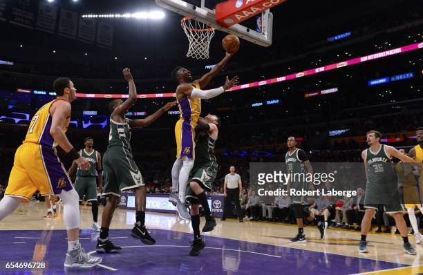 David Nwaba of the Los Angeles Lakers attempts a lay up against Matthew Dellavedova of the Milwaukee Bucks on March 17, 2017 at STAPLES Center in Los...