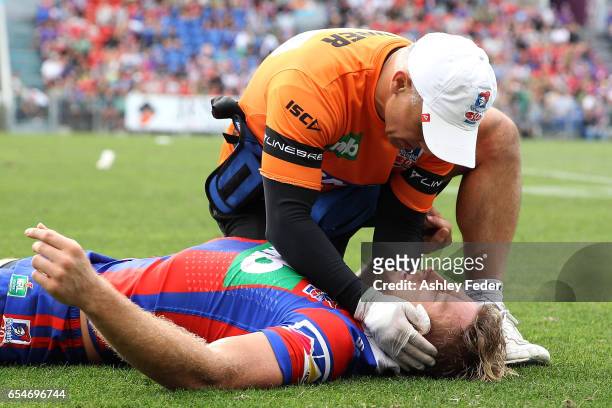 Brendan Elliot of the Knights is treated for injury during the round three NRL match between the Newcastle Knights and the South Sydney Rabbitohs at...