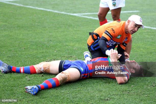 Brendan Elliot of the Knights is treated for injury during the round three NRL match between the Newcastle Knights and the South Sydney Rabbitohs at...