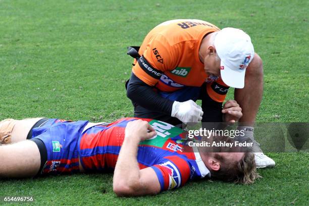 Brendan Elliot of the Knights is treated for injury during the round three NRL match between the Newcastle Knights and the South Sydney Rabbitohs at...