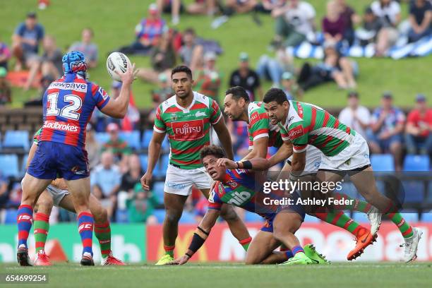 Dane Gagai of the Knights is tackled by the Rabbitohs defence during the round three NRL match between the Newcastle Knights and the South Sydney...