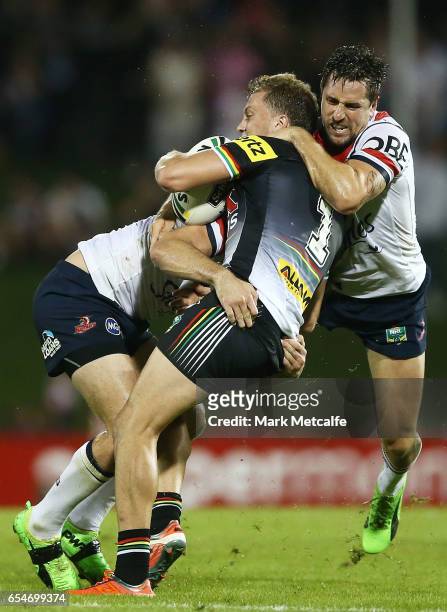 Matt Moylan of the Panthers is tackled by Mitchell Pearce of the Roosters during the round three NRL match between the Penrith Panthers and the...