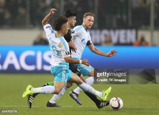 Mahmoud Dahoud of Moenchengladbach and Thilo Kehrer of Schalke and Benedikt Hoewedes battle for the ball during the UEFA Europa League Round of 16...