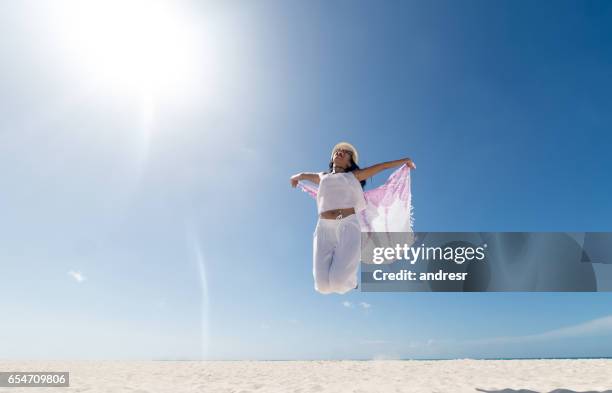 happy woman enjoying her summer holidays at the beach - happy holidays around the world stock pictures, royalty-free photos & images