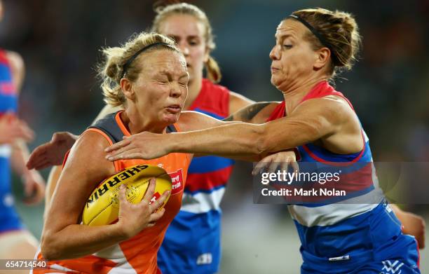 Phoebe McWilliams of the Giants is tackled by Hannah Scott of the Bulldogs during the round seven AFL Women's match between the Greater Western...