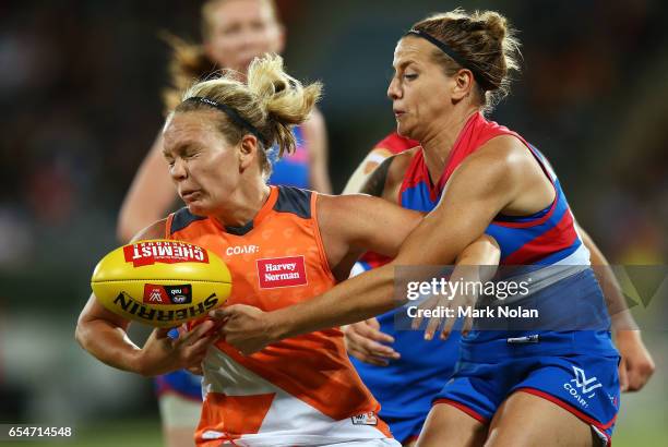 Phoebe McWilliams of the Giants is tackled by Hannah Scott of the Bulldogs during the round seven AFL Women's match between the Greater Western...