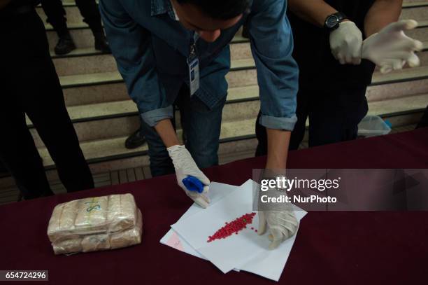 Thai police display seized drugs during a media presentation at their headquarters Bangkok, Thailand, on March 18, 2017. 1 099 tablets of...