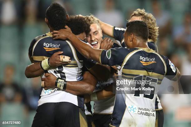 Henry Speight of the Brumbies celebrates with his team mates after scoring a try during the round four Super Rugby match between the Waratahs and the...