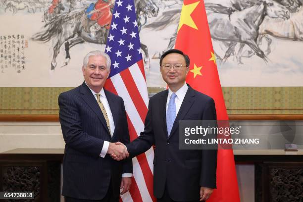 China's State Councilor Yang Jiechi shakes hands with U.S. Secretary of State Rex Tillerson before their meeting at Diaoyutai State Guesthouse in...