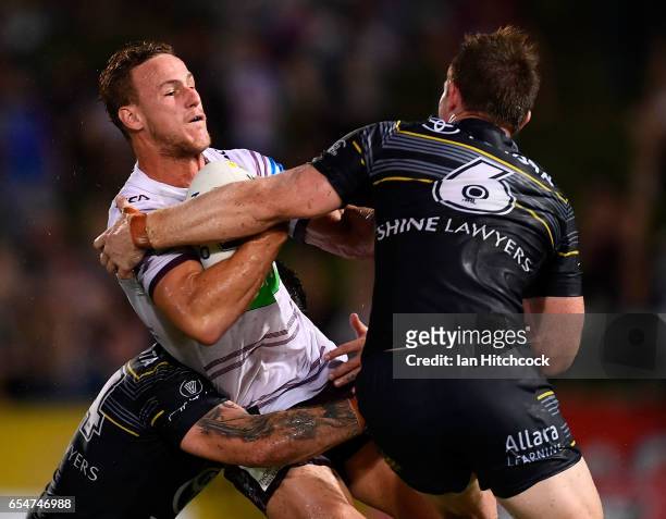 Daly Cherry-Evans of the Sea Eagles is tackled by Michael Morgan of the Cowboys during the round three NRL match between the North Queensland Cowboys...
