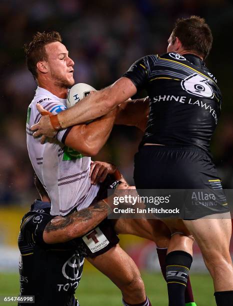 Daly Cherry-Evans of the Sea Eagles is tackled by Michael Morgan of the Cowboys during the round three NRL match between the North Queensland Cowboys...