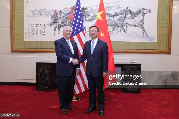 Chinese State Councilor Yang Jiechi shakes hands with U.S. Secretary of State Rex Tillerson before their meeting at Diaoyutai State Guesthouse on...