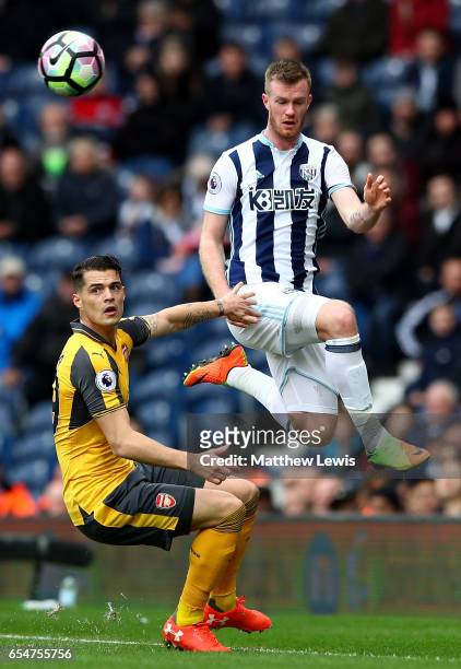 Granit Xhaka of Arsenal looks on as Chris Brunt of West Bromwich Albion wins a header during the Premier League match between West Bromwich Albion...