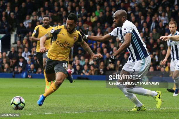 Arsenal's English midfielder Theo Walcott vies with West Bromwich Albion's French-born Cameroonian defender Allan Nyom during the English Premier...