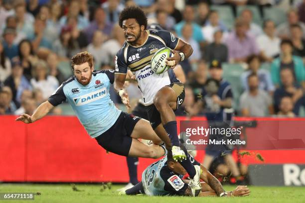 Henry Speight of the Brumbies evades the defence of Andrew Kellaway and Israel Folau of the Waratahs in his way to scoring a try during the round...