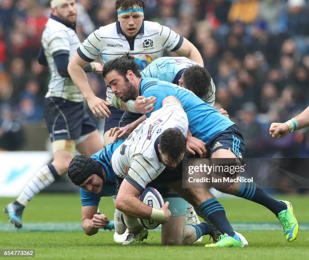 Alex Dunbar of Scotland is tackled by Carlo Canna and Luke McLean of Italy during the RBS Six Nations match between Scotland and Italy at Murrayfield...