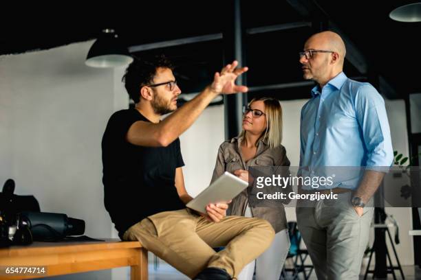 explaining next business moves - colleagues brainstorming stock pictures, royalty-free photos & images