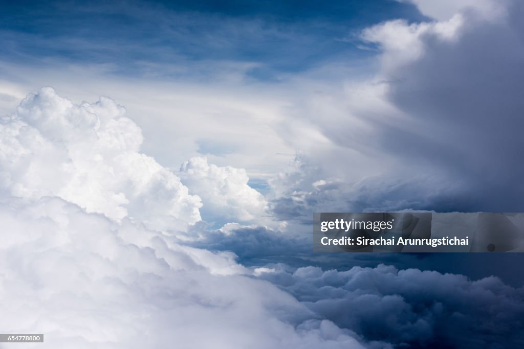 Moody cumulus clouds over the sky during flight