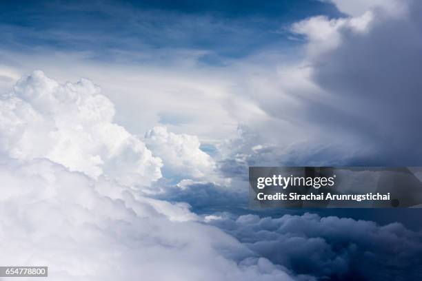 moody cumulus clouds over the sky during flight - atmospheric mood stock pictures, royalty-free photos & images