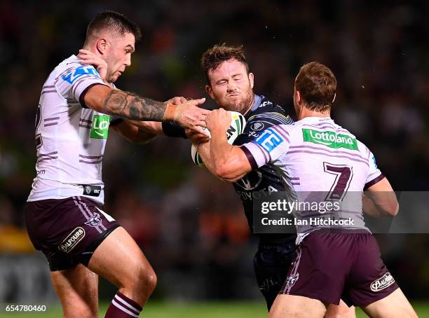 Gavin Cooper of the Cowboys is tackled by Daly Cherry-Evans and Curtis Sironen of the Sea Eagles during the round three NRL match between the North...