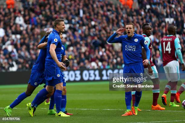 Robert Huth of Leicester City celebrates scoring his sides second goal with Jamie Vardy of Leicester City during the Premier League match between...
