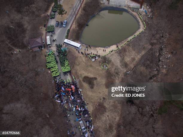 An aerial view shows a protest at the site of a recently installed anti Terminal High Altitude Area Defense system, in Seongju on March 18, 2017....