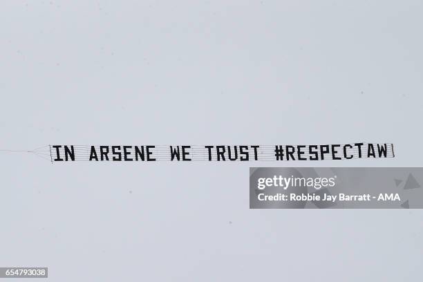 Plane tows a banner supporting Arsene Wenger during the Premier League match between West Bromwich Albion and Arsenal at The Hawthorns on March 18,...