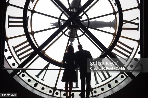 Catherine, Duchess of Cambridge and Prince William, Duke of Cambridge look through the clock at Musee d'Orsay during an official two-day visit to...