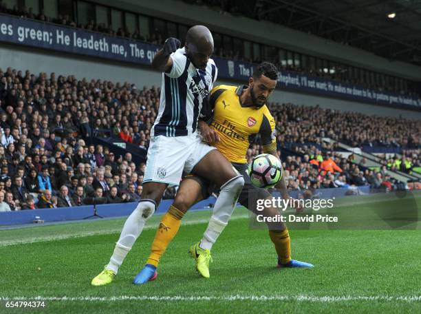 Theo Walcott of Arsenal challenges Allan Nyom of WBA during the Premier League match between West Bromwich Albion and Arsenal at The Hawthorns on...