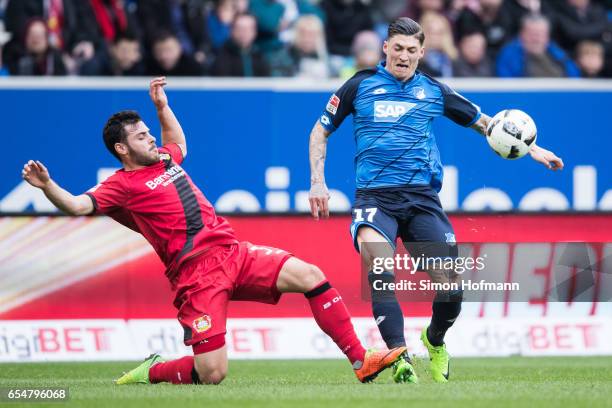 Steven Zuber of Hoffenheim is challenged by Kevin Volland of Leverkusen during the Bundesliga match between TSG 1899 Hoffenheim and Bayer 04...